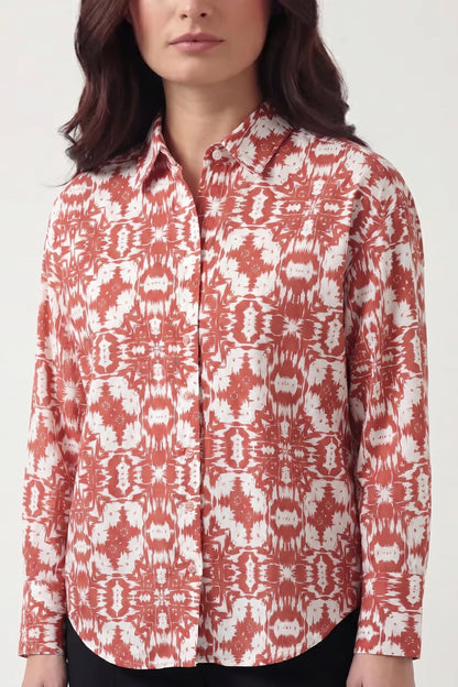 Woman wearing a red and white patterned shirt on a white background