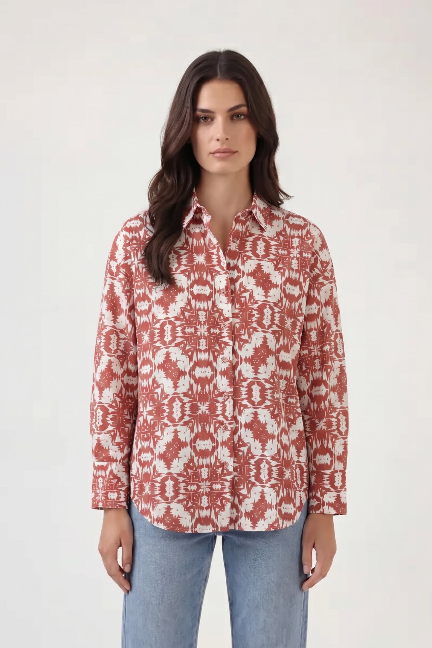 Woman wearing a red and white patterned shirt on a white background